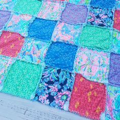 a colorful patchwork quilt on a wooden table