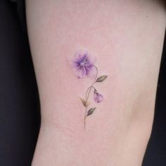 a purple flower on the side of a woman's stomach