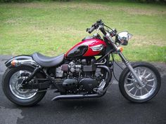 a red and black motorcycle parked on the street