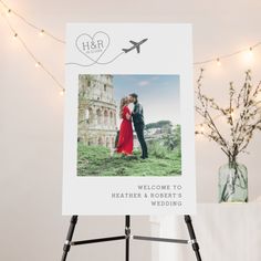 a welcome sign with an image of a man and woman in red dress standing next to each other