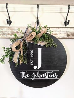 a sign that says the johnston's hanging from a hook on a wall