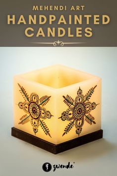 a lit candle with the words mehndi art handpainted candles