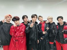 group of young men in raincoats posing for the camera with their fingers up