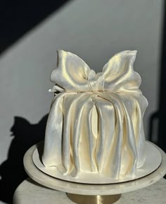 a white cake with a large bow on top