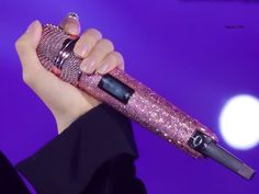 a close up of a person holding a microphone