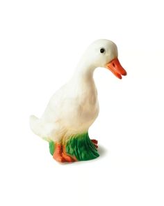 a white duck with orange beak and green legs