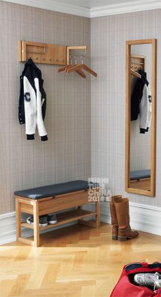 a bench and coat rack in a room