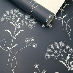 a black and white floral wallpaper with silver foiling on it's edges