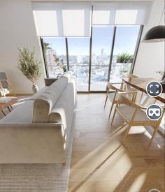 a living room filled with furniture and lots of windows