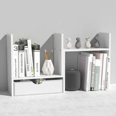 three bookshelves with different types of books and vases on them, all in white