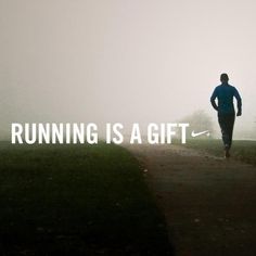 a man running down a path with the words running is a gift