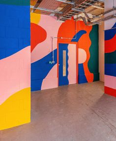 an empty room with colorful painted walls