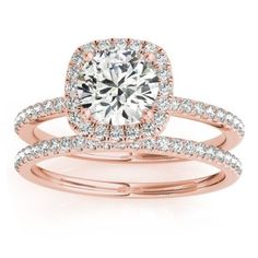 an engagement ring set with a cushion cut diamond in the center and two rows of pave