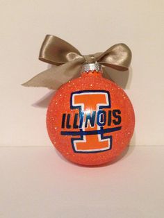 an orange ornament with the word illinois on it and a bow hanging from it