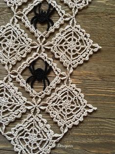 a crocheted doily with a black spider on it