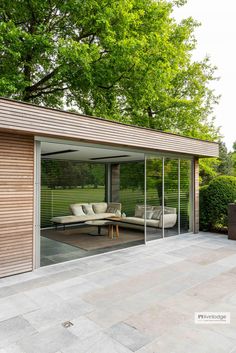 an outdoor living room with sliding glass doors