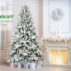 a white christmas tree sitting in front of a fireplace