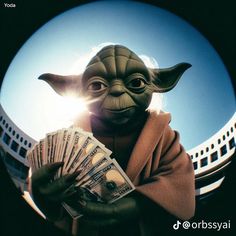 an image of yoda holding cash in front of a camera lens with the sun shining behind it