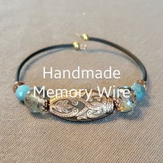 the handmade memory wire bracelet is decorated with blue glass beads and gold metal clasps