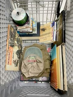 a shopping cart filled with books and other items