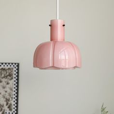 a pink light hanging from a ceiling in a room