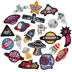 a bunch of patches that are in the shape of an alien and space shuttles