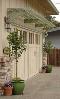 several potted plants in front of a house