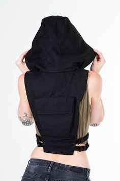 Ninja Kombat Hooded Crop Top Vest in Jet Black Canvas One part haute couture streetwear and two parts assassin, this leather harness vest invites intrigue and mystery, and mercilessly slays everything and everyone in it's path. Featuring a utilitarian pocket on the back, a zip closure front and adjustable side straps to keep in tune with a refined and foxy silhouette, be forewarned that when you wear this, you're going to turn heads ( and maybe crack some necks ). Shrinking violets need not appl Techwear Crop Top, Couture Streetwear, Custom Outfits, Hooded Crop Top, Tech Wear, Techwear Fashion, Dr Closet, Leather Bra, Crop Vest