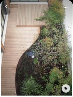 an aerial view of a house with trees and plants