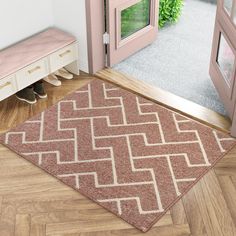 a door way with a rug on the floor in front of it and pink doors