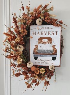 the front door is decorated with an autumn wreath and a sign that reads, i am fresh harvest