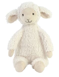 a white stuffed sheep sitting up against a white background