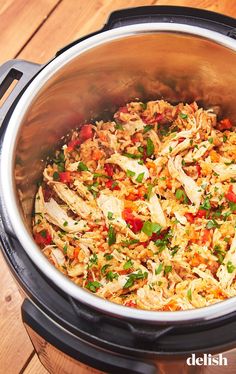 a large pot filled with food on top of a wooden table