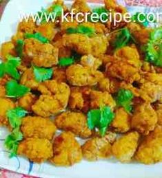 fried food on a white plate with green garnishes and parsley sprigs