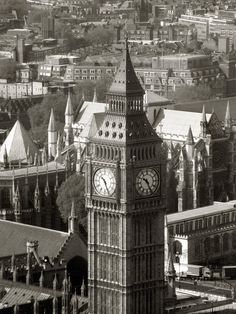 the big ben clock tower towering over the city of london, england in black and white