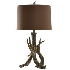 an antler lamp with a brown shade on it