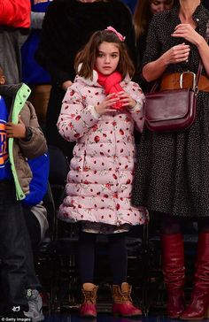 Suri Cruise was spotted sitting courtside with her celebrity mom Katie Holmes at the Oklahoma City Thunder vs. NY Knicks NBA game in New York City. She kept warm in this pretty pink Dolce & Gabbana Coccinelle Ladybird print down puffer coat. It’s on sale! #suricruise #katiehomes #celebrity #kidsfashion #dolcegabbana Tom Cruise And Suri, Sitting Courtside, Famous Babies, Pink Ladybug, Ny Knicks, Nba Game, Gay Pride Parade