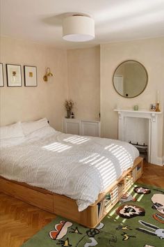 a bed sitting on top of a hard wood floor next to a fire place in a bedroom