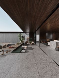 an outdoor living area with concrete floors and wooden ceiling