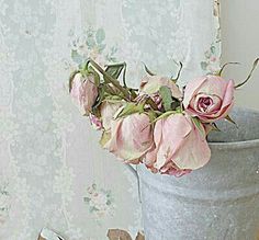 a vase with flowers in it sitting on a table next to a pair of scissors