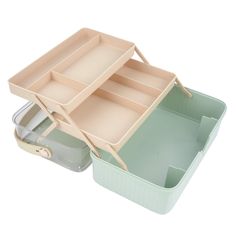 two trays with compartments on top of each other, one is green and the other is beige