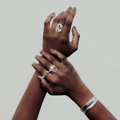 two hands reaching up to each other with rings on their fingers and one holding the other's hand