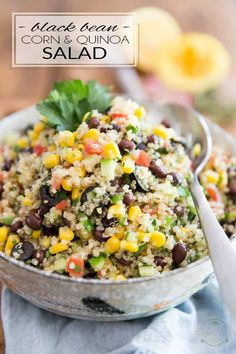 black bean corn and quinoa salad in a bowl with a spoon on the side