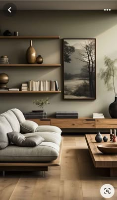 a living room filled with lots of furniture next to a wall mounted painting on the wall