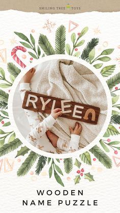 a baby laying on top of a wooden name puzzle