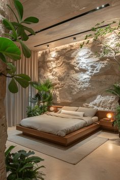 a large bed sitting in the middle of a bedroom next to a plant filled wall