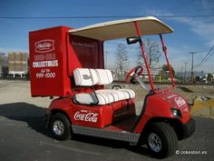 a red golf cart parked in a parking lot