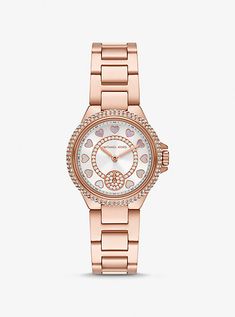 Reimagined for the season, the Camille watch is back and chicer than ever. This rose-gold stainless steel timepiece is updated with heart-shaped time stops and crowned with pavé accents for a touch of sparkle. The mini size means that you’ll find it comfortable to wear all day. Heart Watch, Rose Gold Watch, Michael Kors Watch, Gold Watch, Time Piece, Gold Tones, Michael Kors, Water Resistant