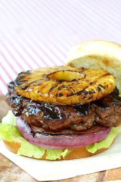 a grilled burger with pineapple on top