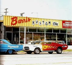 two classic cars parked in front of a building